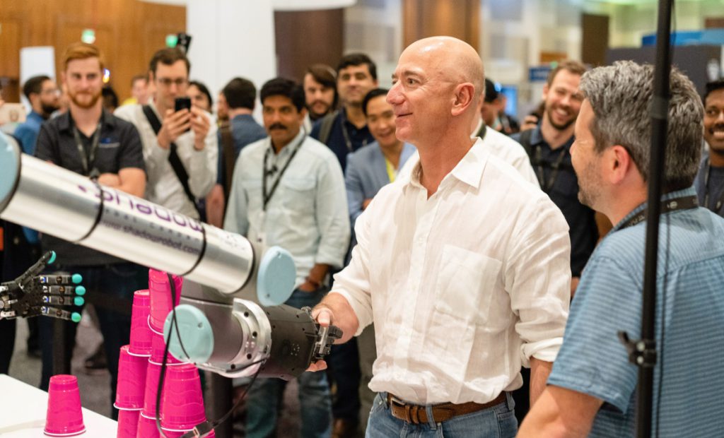jeff bezos shaking hands with shadow dexterous hand at re:mars 2019