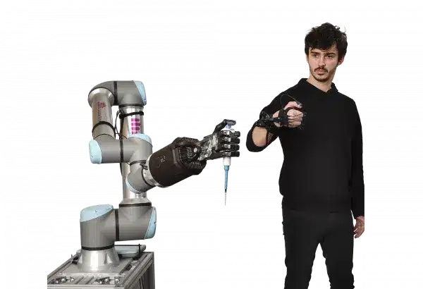 image showing man controlling one robot arm with a shadow glove to use a syringe