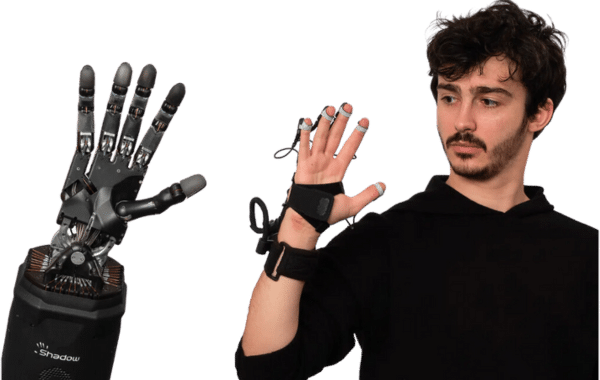 man wearing shadow glove with the dexterous robot hand waving