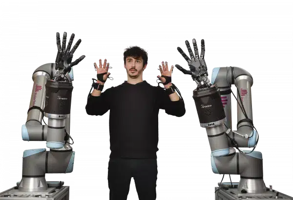 picture showing two robot arms being controlled by a man wearing the shadow glove